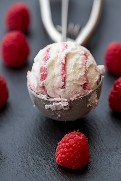 istock Raspberry-vanilla-icecream in icecream scoop, fresh raspberries on slate 482519820