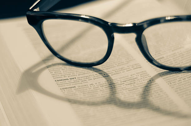 istock Open dictionary and glasses - word 
