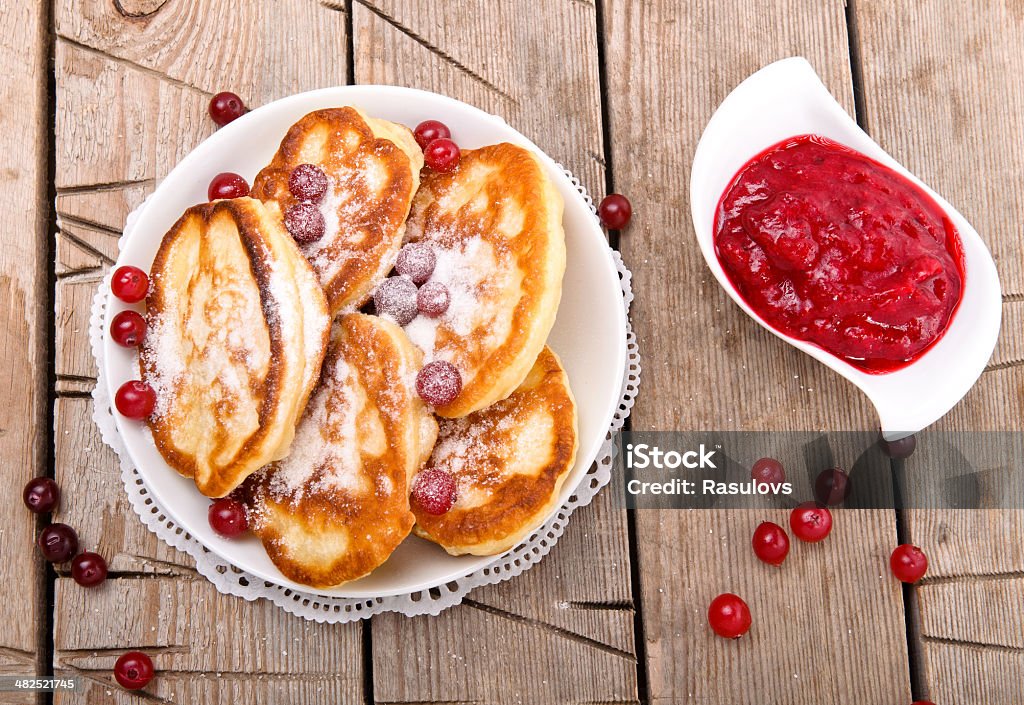 Pancakes Pancakes in a white plate on a wooden table American Culture Stock Photo