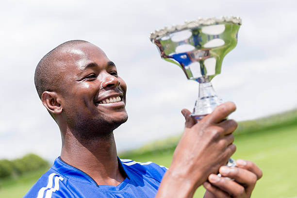 istock Football player lifting the trophy 482521837
