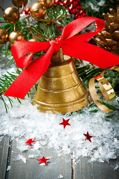 istock Christmas golden bell with red satin ribbon bow 482523308