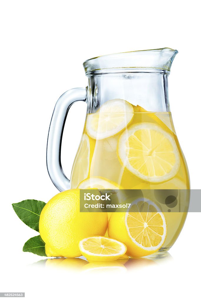 Lemonade pitcher with lemons Lemonade pitcher with lemon slices and ice cubes isolated on white Lemonade Stock Photo