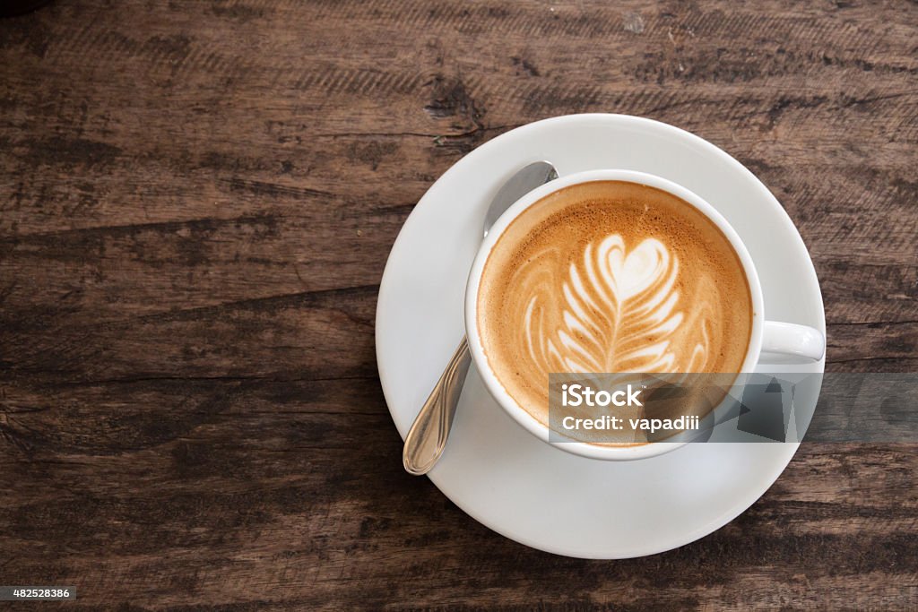 Cup of heart latte art Cup of heart latte art on wood table Cappuccino Stock Photo