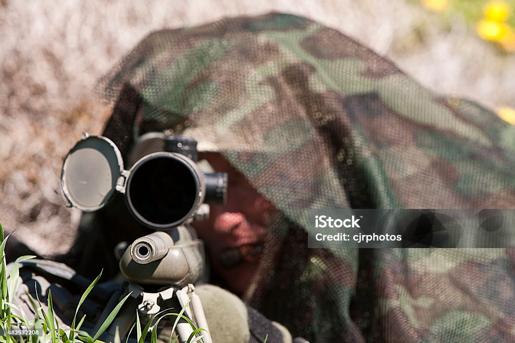 Sniper An unidentified marksman taking aim with his rifle. 2015 Stock Photo