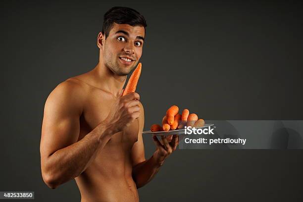 Young Man With Carrots Stock Photo - Download Image Now - 2015, Active Lifestyle, Adult