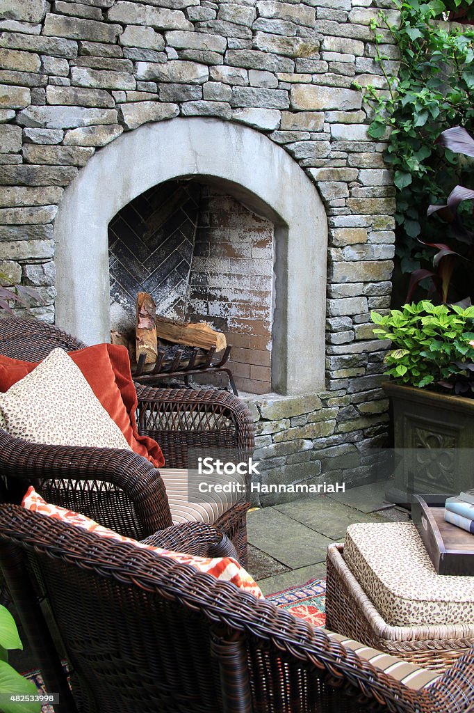 Outdoor garden fireplace Outdoor living. A fireplace, lounge chairs and coffee table in the garden. Fireplace Stock Photo