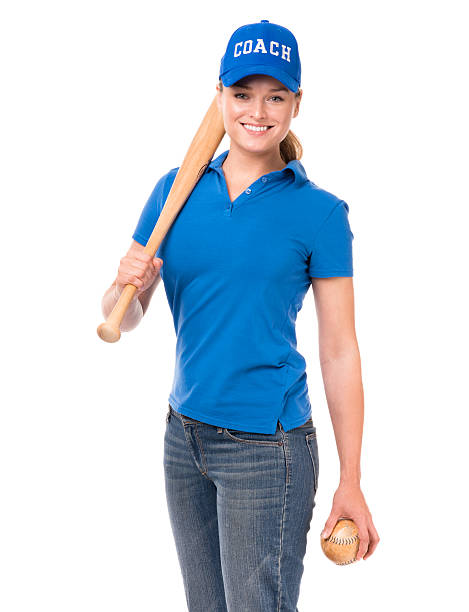 Studio shot of a young woman holding a baseball bat and looking at the camera isolated on white background