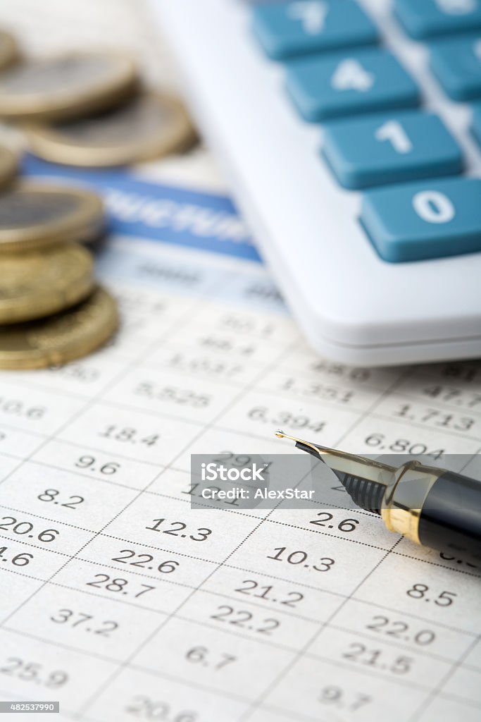 finance report Calculator, coins and pen on finance report Calculator Stock Photo