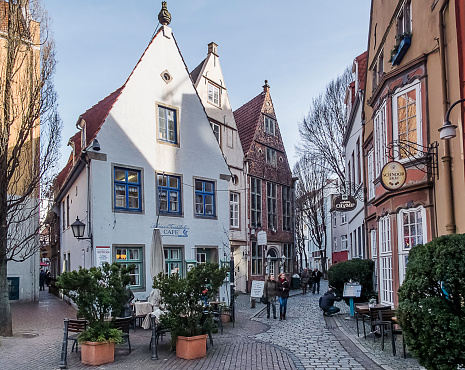 Bremen, Germany - February 24, 2014: Pedestrians walk on a street in Bremen Schnoor quarter between cafes and pubs.