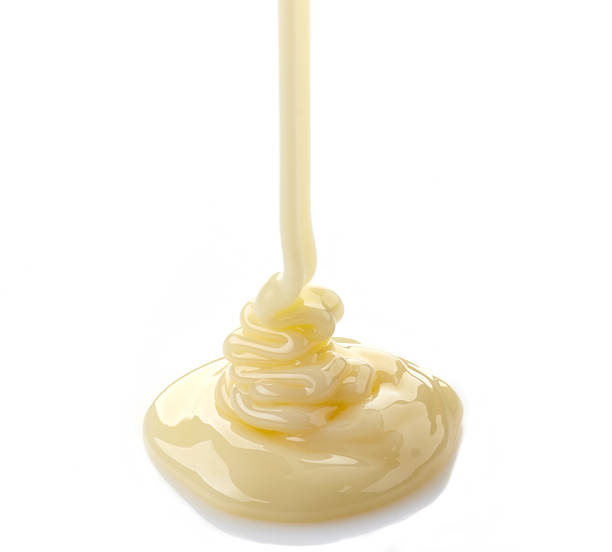 istock pouring condensed milk on a white background 482543391