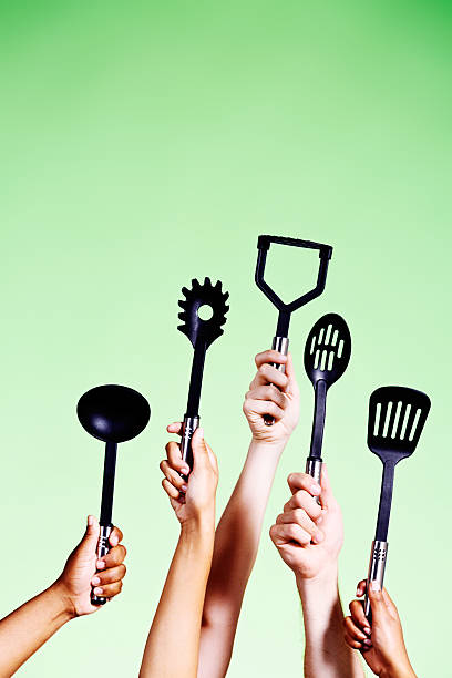 istock Five hands volunteering to cook hold mixed utensils 482544325
