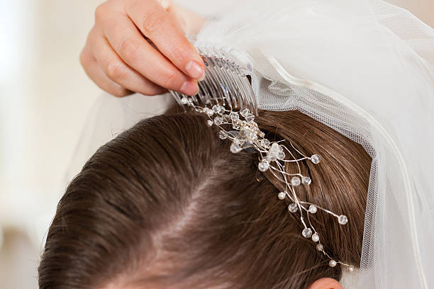 istock Stylist pinning up a bride's hairstyle 482545529