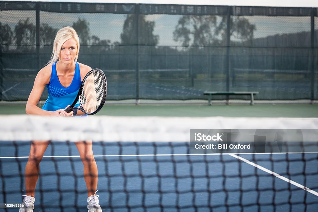 Playing Tennis Woman on tennis court playing tennis. 2015 Stock Photo
