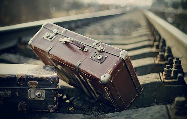 istock Old fashioned a suitcases on railroad tracks 482546610