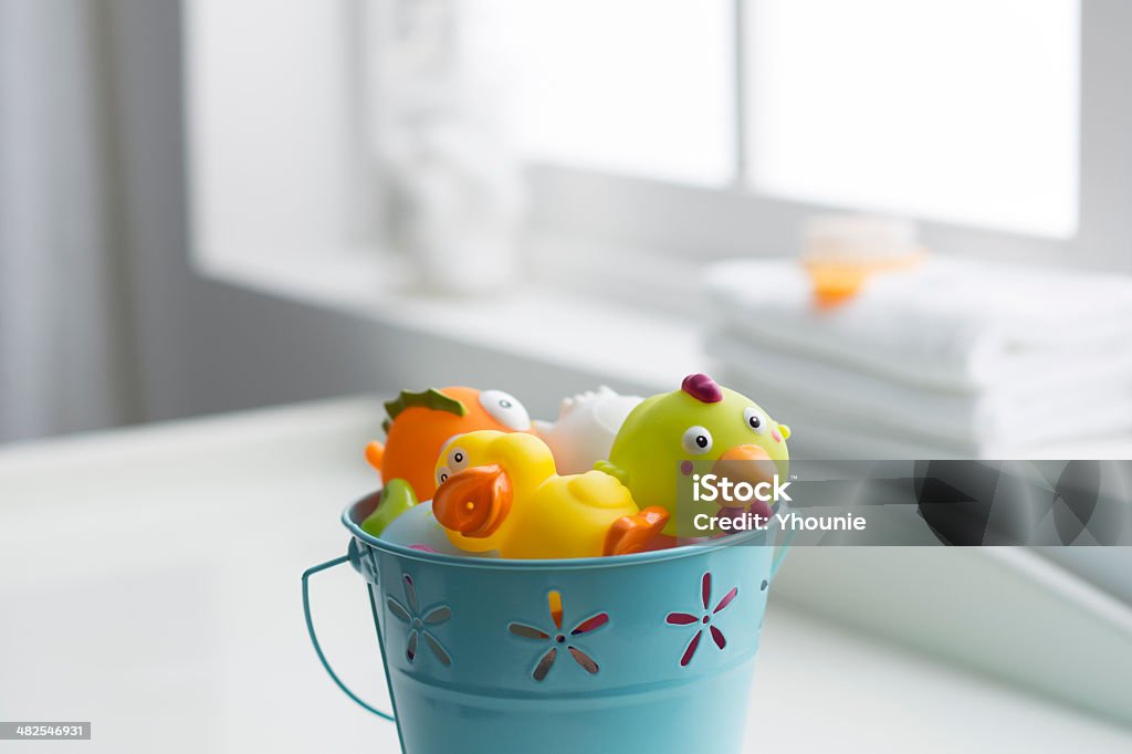 baby's room turquoise pail full of toys on a white baby bedroom Baby - Human Age Stock Photo