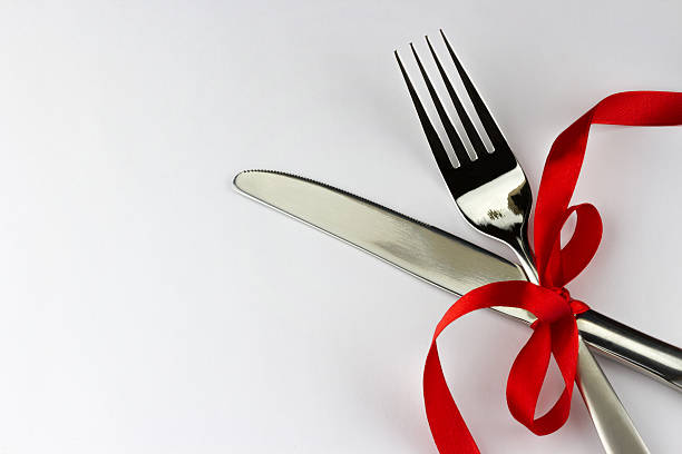istock Silver fork and knife decorated red ribbon with bow 482547038