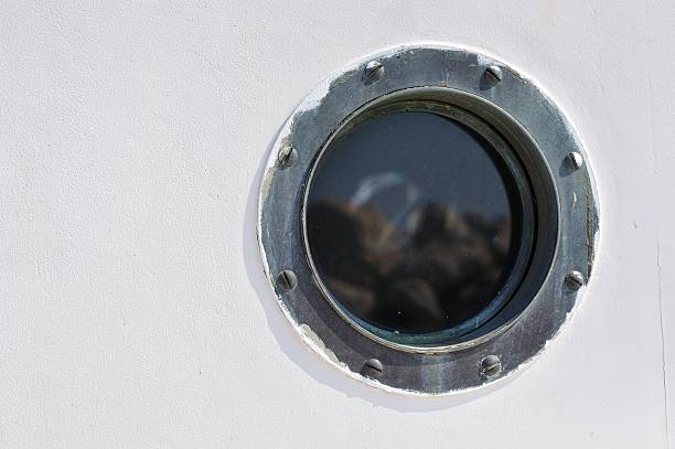 Porthole in the white hull of passenger ship