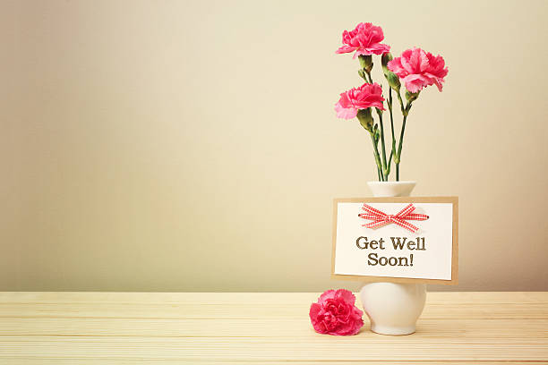 Get well soon message with pink carnations Get well soon message with pink carnations in a white vase get well soon stock pictures, royalty-free photos & images