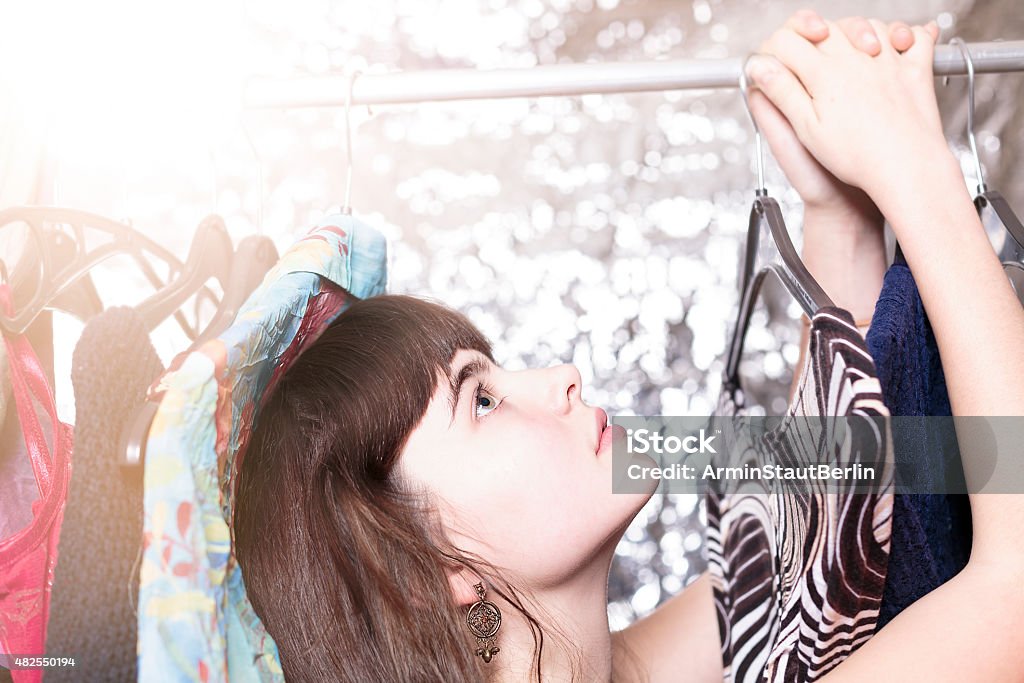 teenage girl and her wardrobe, with bokeh portrait of a beautiful teenage girl and her wardrobe, with bokeh 2015 Stock Photo