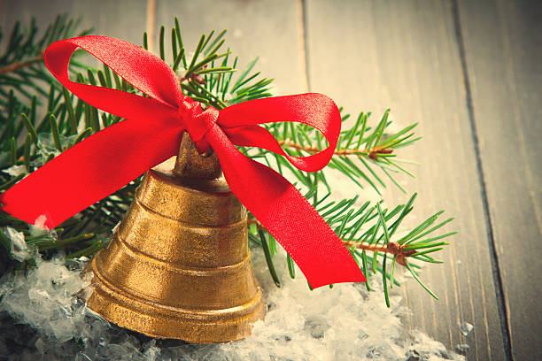 istock Christmas golden bell with red satin ribbon bow 482551576