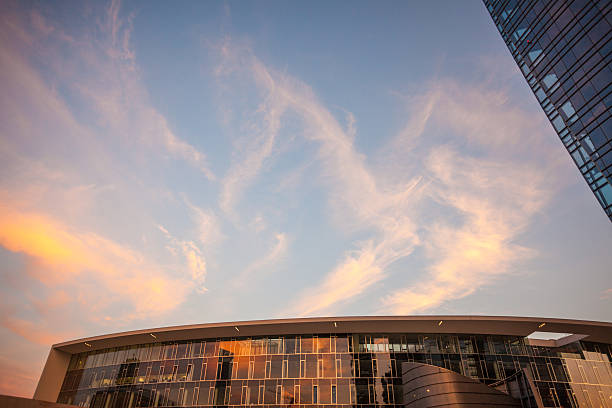 istock Curved building, glasses, orange and blue sky 482551612