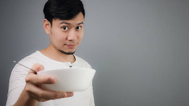 istock Asian man holding white bowl. 482551840