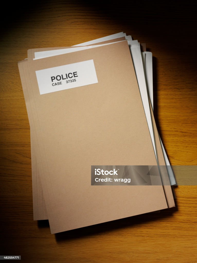 Police Files on the Desk with Copy Space Police paper files on a wooden desk, overhead view. Copy space File Folder Stock Photo