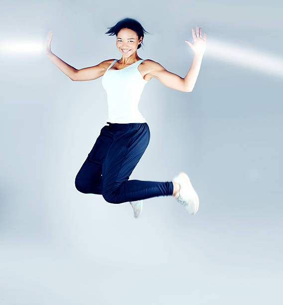 istock Smiling brunette woman jumping 482554818