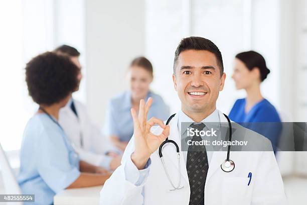 Happy Doctor Over Group Of Medics At Hospital Stock Photo - Download Image Now - Doctor, 2015, Adult