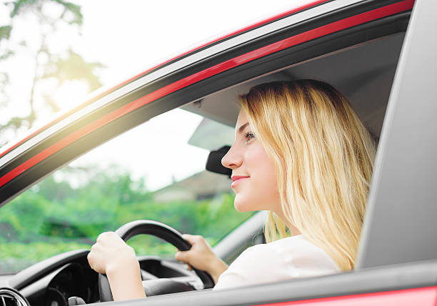 istock Woman in red car 482555720