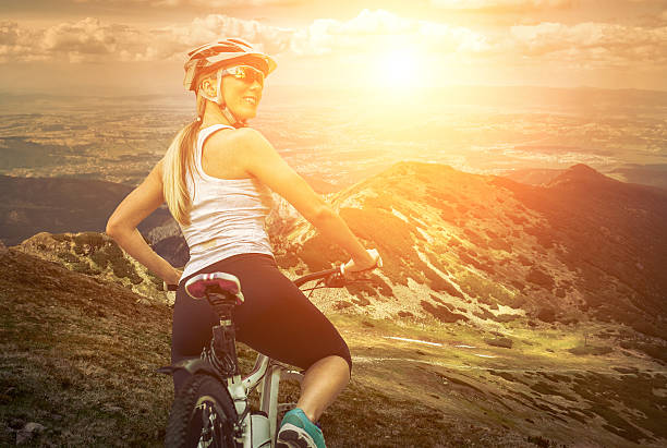 istock woman stay on the bicycle around mountains 482556640