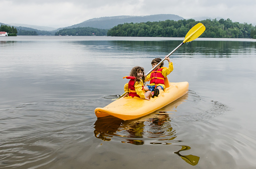 Young boy and girl  kayaking on lake Sept-Iles (Portneuf)