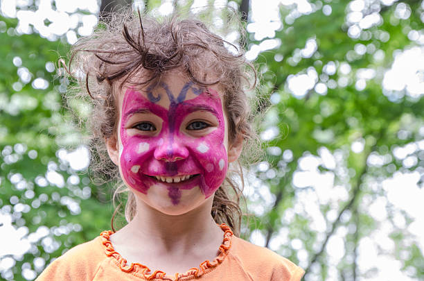 istock Little girl with butterfly painted on her face 482556936