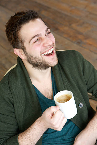 istock Man smiling with cup of coffee 482557401