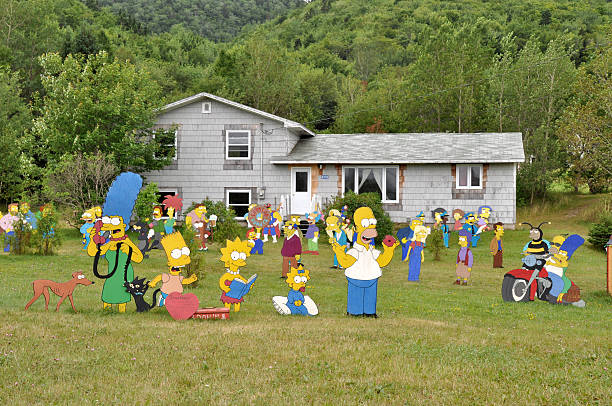 Simpsons in the garden Cape Breton, CANADA - July 27, 2013: cardboard cut-outs of the Simpsons charakters in a private garden near Baddeck on Cape Breton Island, Canada television show stock pictures, royalty-free photos & images