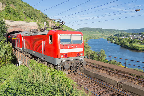 istock Train leaving a tunnel along river Moselle in Germany 482559489