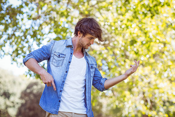 handsome hipster pretend to pay the guitar handsome hipster pretend to pay the guitar in a summer day air guitar stock pictures, royalty-free photos & images