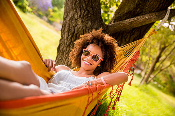istock Young woman relaxing in a hammock 482559595