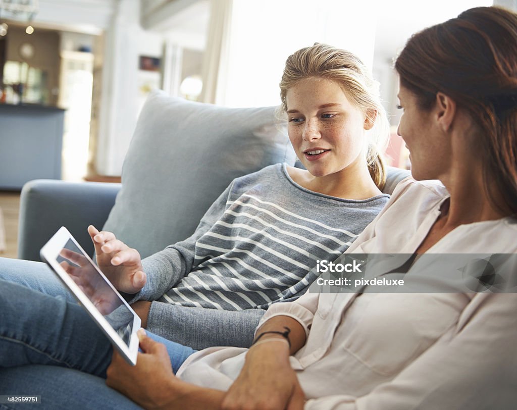 Having a mother to daugther talk A mom and her teenage daughter spending some quality time together in the living room Teenager Stock Photo