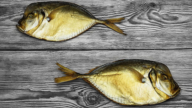istock two smoked fish on the wooden table closeup 482559804