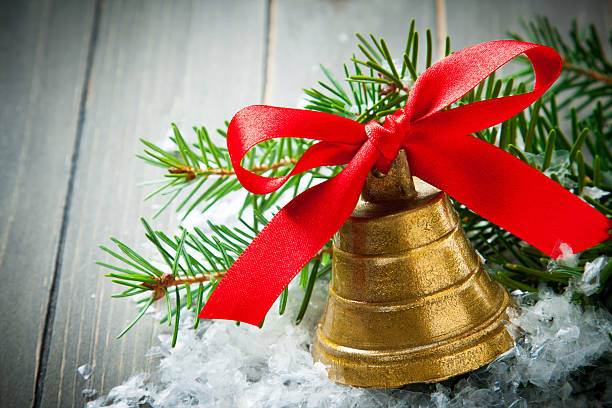 istock Christmas golden bell with red satin ribbon bow 482559886