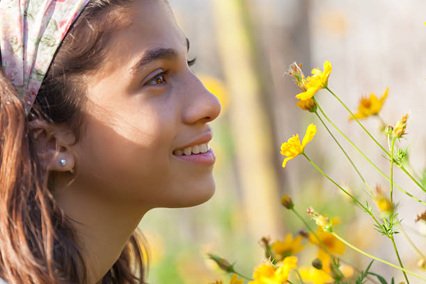 Little girl holding bouquet of spring yellow flowers