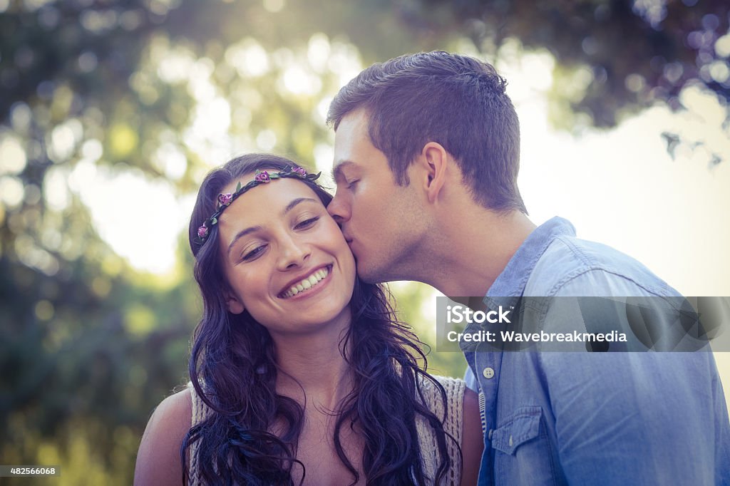 Cute couple kissing in the park Cute couple kissing in the park on a sunny day 20-24 Years Stock Photo