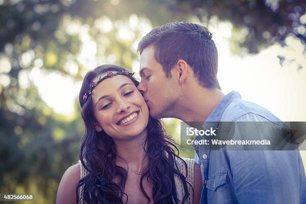 Cute Couple Kissing In The Park Stock Photo - Download Image Now - 20-24 Years, 20-29 Years, 2015