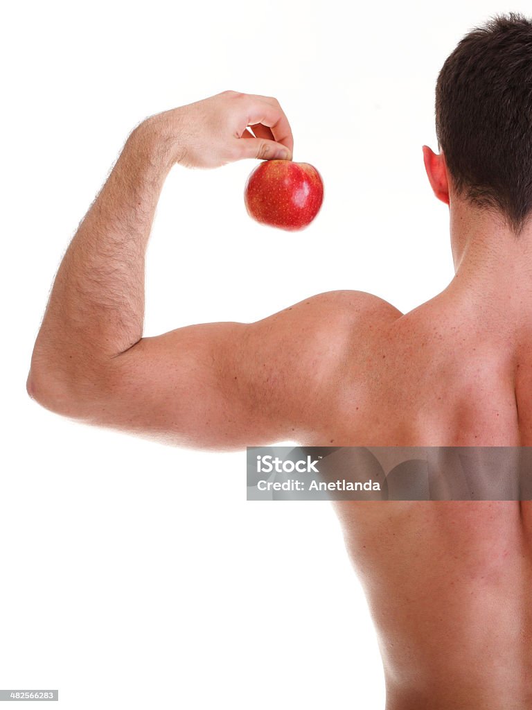 Culturista maschio atletico sexy con Mela rossa - Foto stock royalty-free di Addome umano