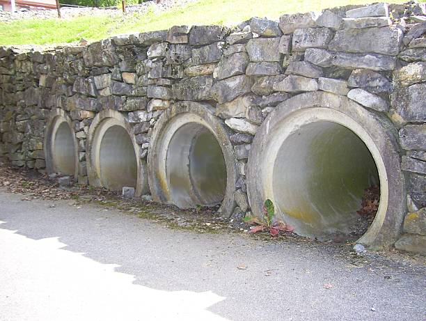 Row of Culverts Surrounded by a Rock Wall stock photo