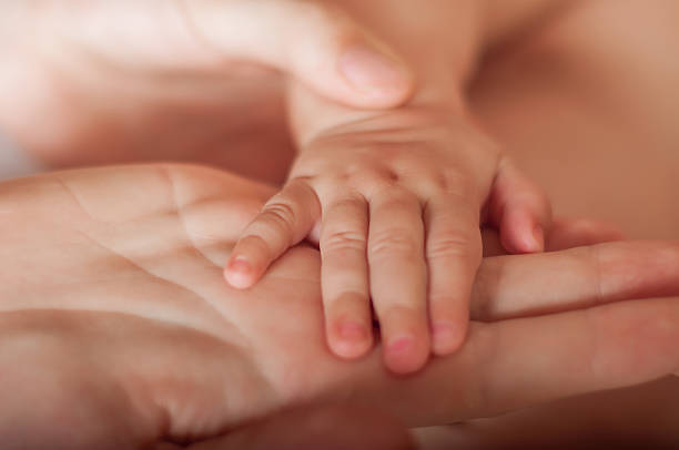 istock Small baby hand in mother's hands 482567795