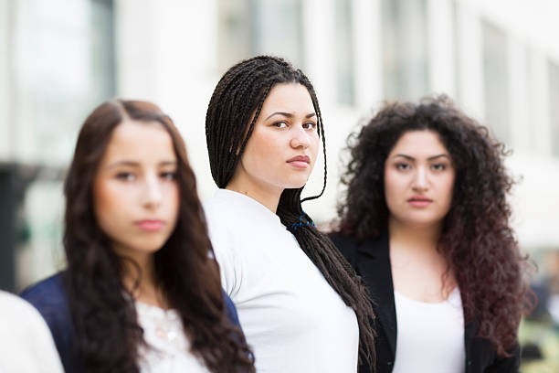 istock three diverse young women in a row 482568273
