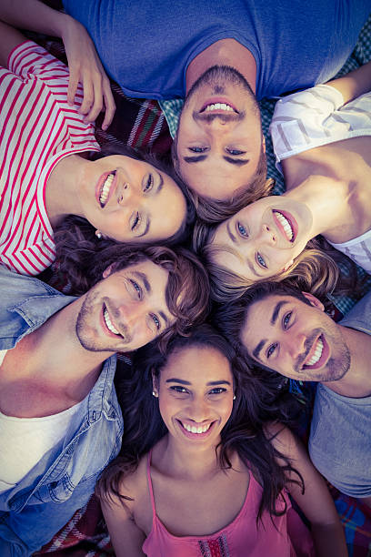 istock happy friends in park huddling in circle 482569572