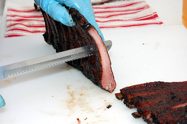 istock Slicing pork ribs apart in preperation for a meal 482569608